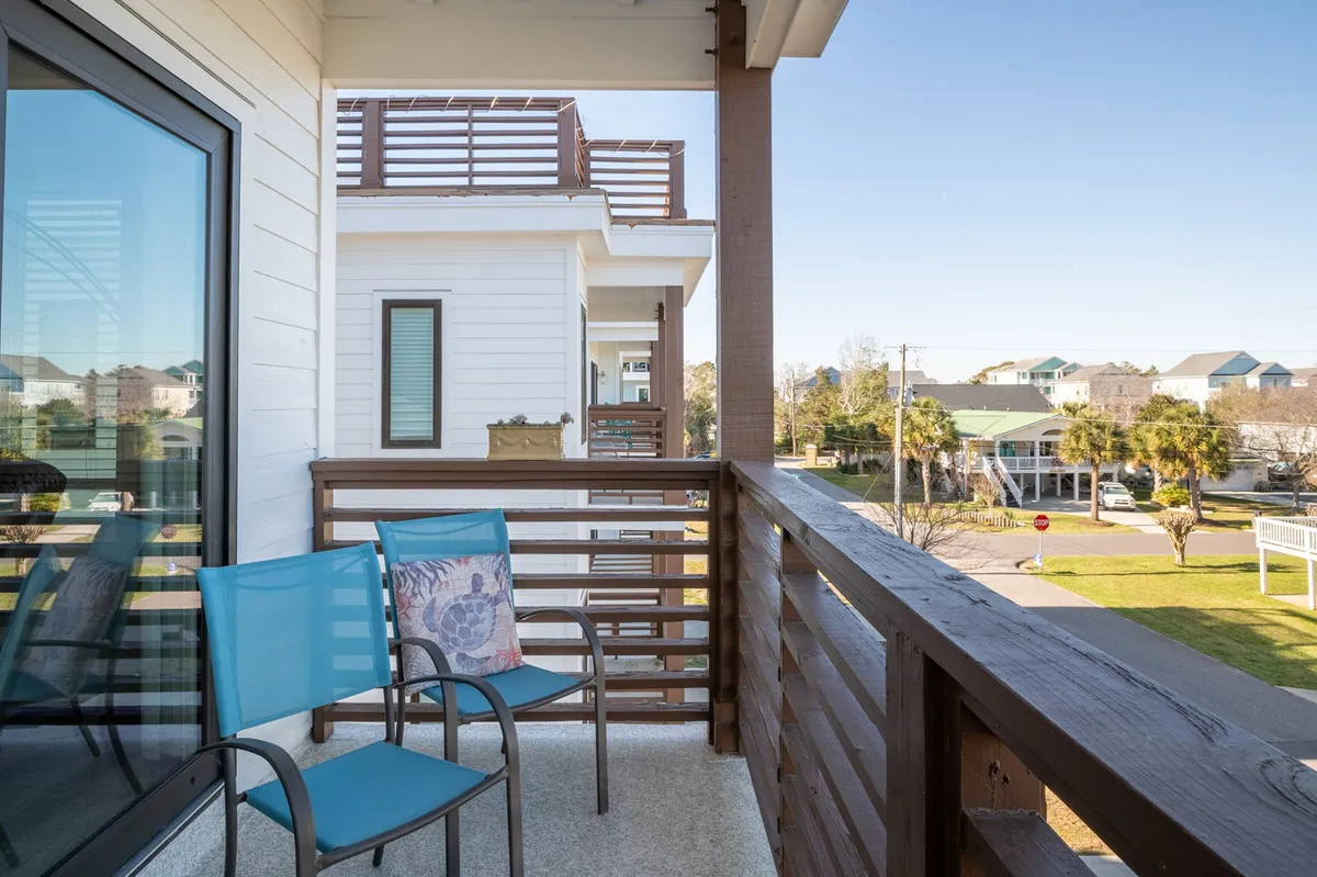 This exterior photo shows balcony chairs positioned to take in a landscape view over the balcony railing. The tranquil scene suggests a quiet spot to relax, read, or enjoy the view after a day spent exploring nature.
